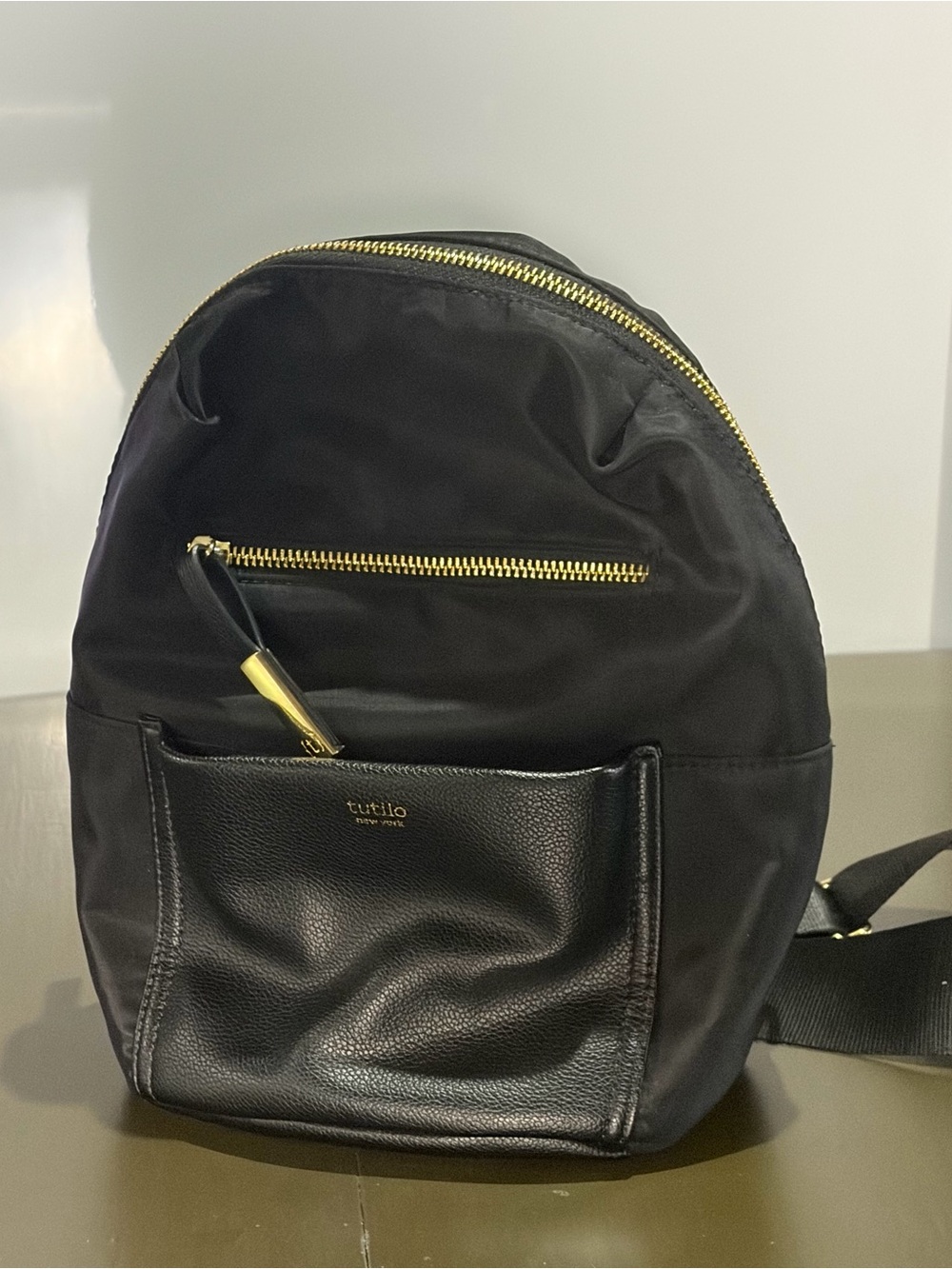 Tutilo New York Black Nylon/Vinyl Mini Backpack with Gold Zipper.